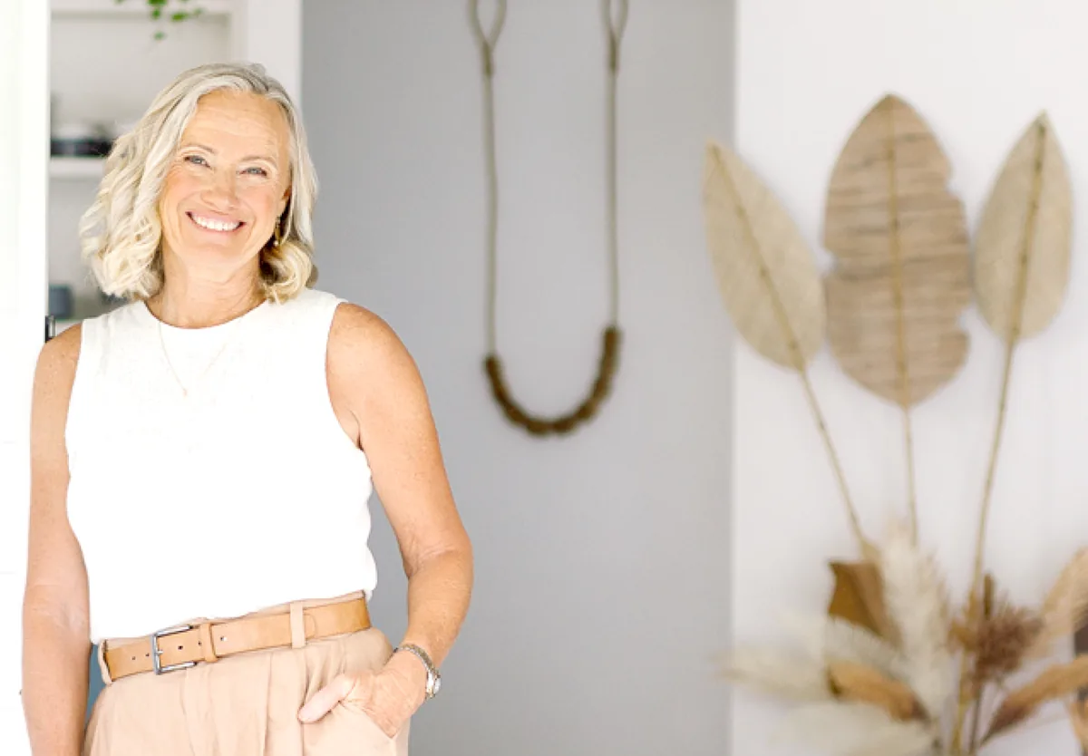 Cyndi O’Meara smiling, standing in a bright room